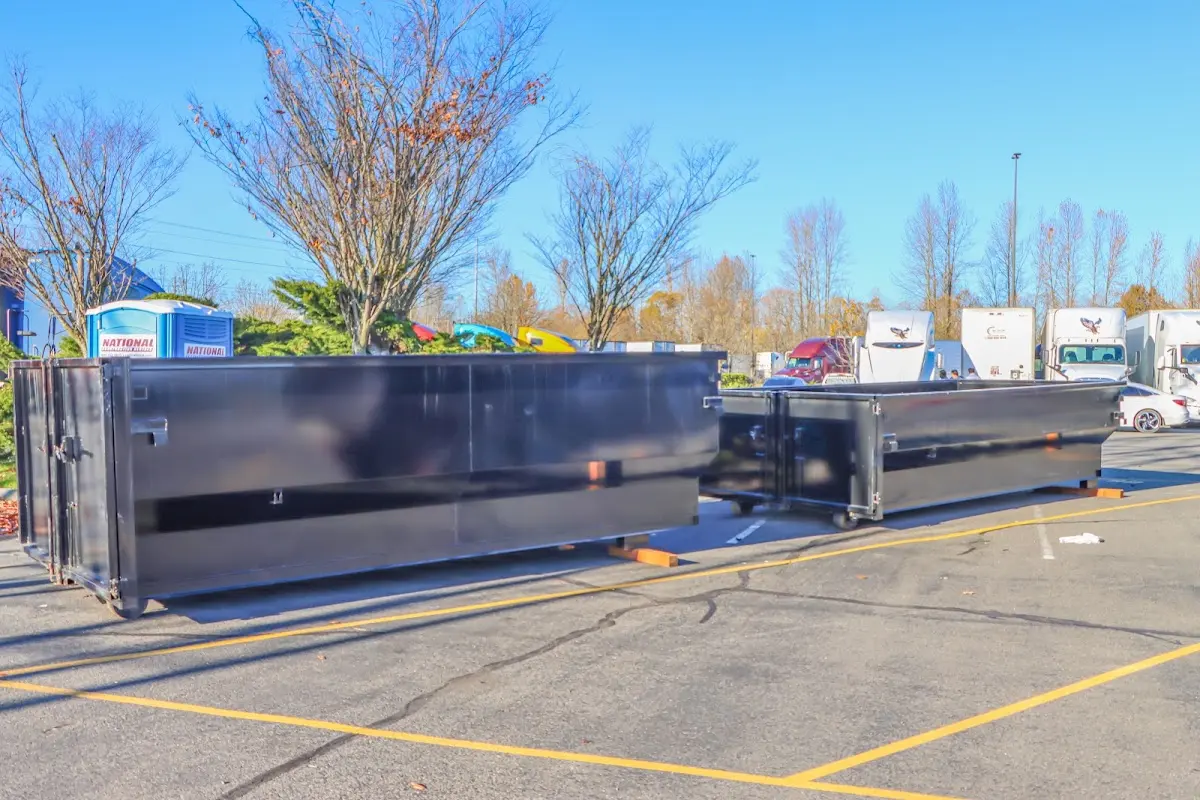 Professional dumpster rental service with roll-off container on residential driveway in Herndon